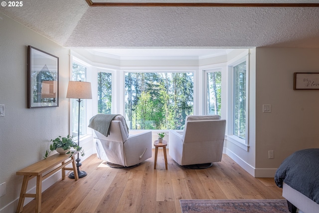 8751 SW 194th Pl, Beaverton, OR 97007 - living room with wood finished floors, a textured ceiling, and ornamental molding