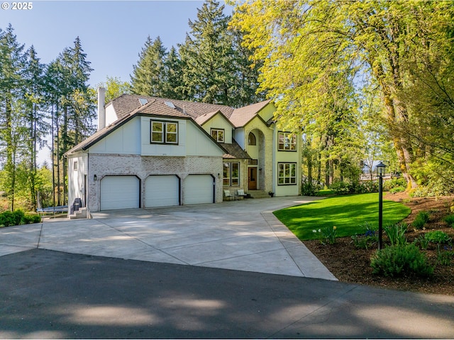 8751 SW 194th Pl, Beaverton, OR 97007 - view of front facade featuring a chimney, an attached garage, driveway, a front yard, and board and batten siding