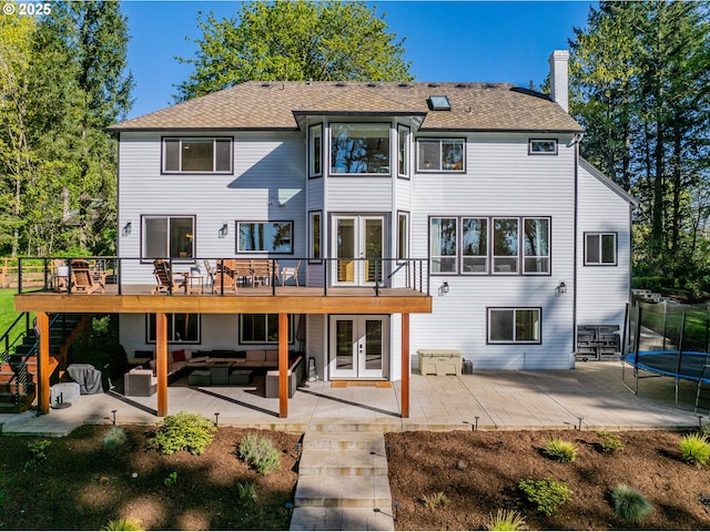 8751 SW 194th Pl, Beaverton, OR 97007 - rear view of house featuring french doors, outdoor lounge area, a trampoline, a deck, and a patio area