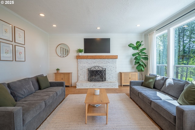 8751 SW 194th Pl, Beaverton, OR 97007 - living room featuring ornamental molding, light wood-type flooring, a brick fireplace, recessed lighting, and a textured ceiling