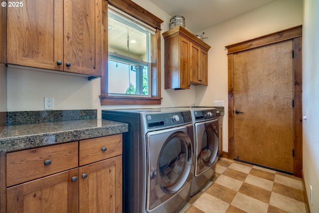 laundry room with cabinet space, washing machine and clothes dryer, and light floors