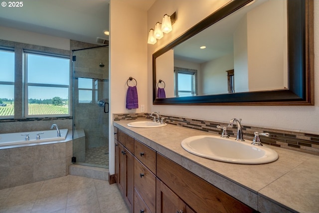 full bathroom featuring tile patterned floors, a stall shower, a garden tub, double vanity, and tasteful backsplash