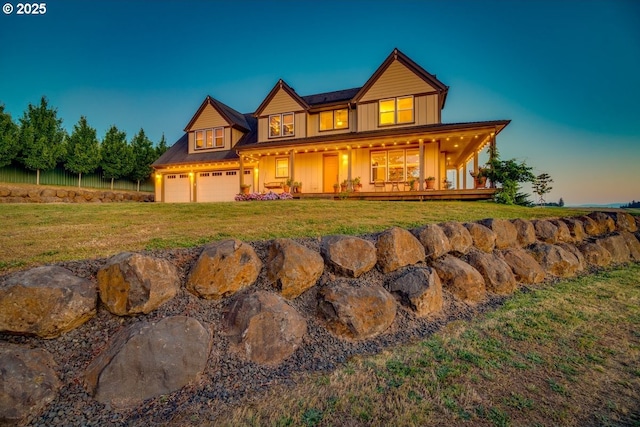 view of front of house featuring a porch, a front yard, a garage, and board and batten siding