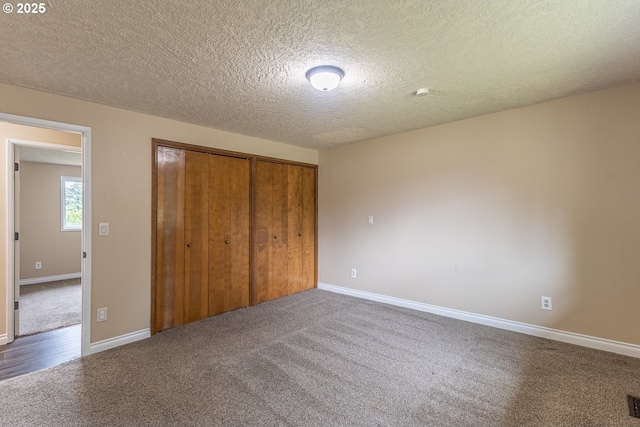 3026 NW Norwood St, Camas, WA 98607 - unfurnished bedroom featuring carpet, a closet, baseboards, and a textured ceiling