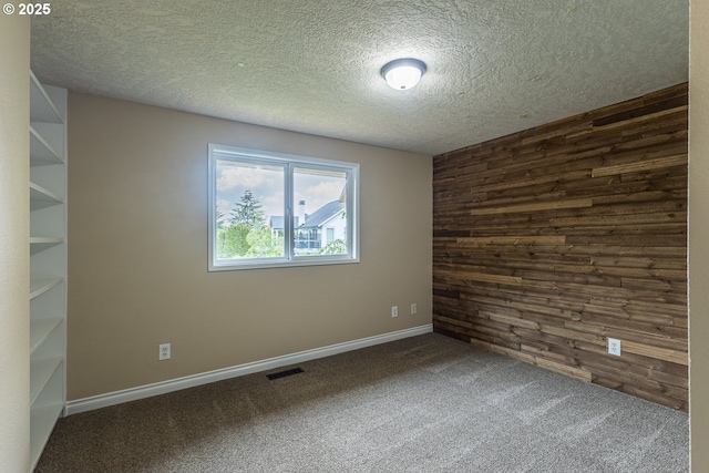 3026 NW Norwood St, Camas, WA 98607 - spare room with wooden walls, carpet floors, and a textured ceiling
