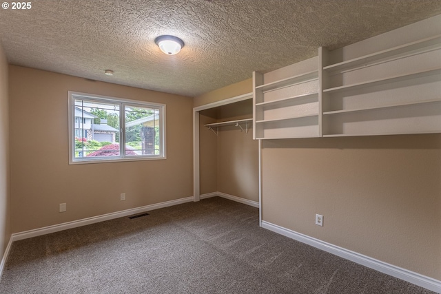 3026 NW Norwood St, Camas, WA 98607 - unfurnished bedroom featuring dark colored carpet, baseboards, a textured ceiling, and a closet