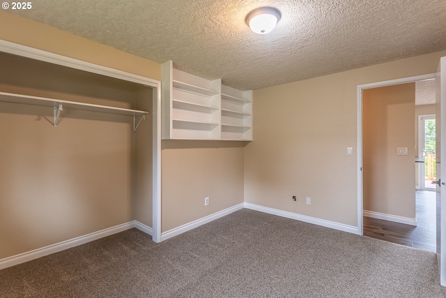 3026 NW Norwood St, Camas, WA 98607 - unfurnished bedroom with dark colored carpet, a closet, a textured ceiling, and baseboards