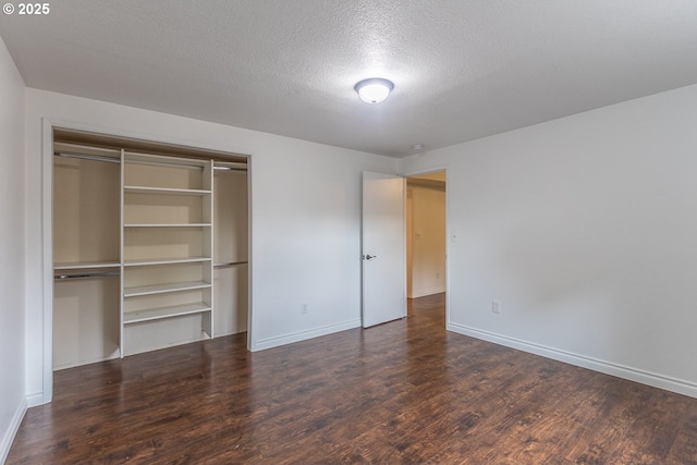3026 NW Norwood St, Camas, WA 98607 - unfurnished bedroom with wood finished floors, a closet, baseboards, and a textured ceiling