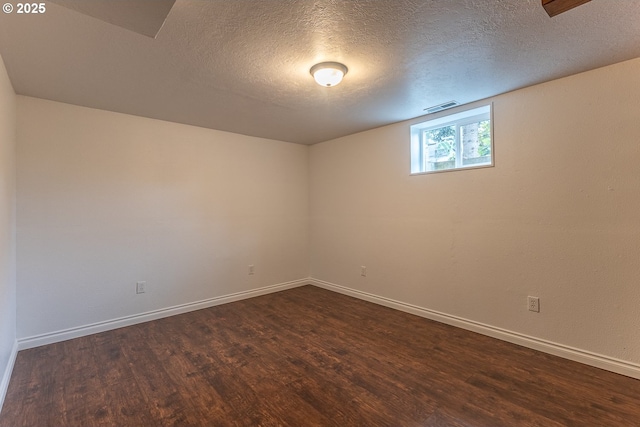 3026 NW Norwood St, Camas, WA 98607 - unfurnished room with dark wood-style flooring, a textured ceiling, and baseboards