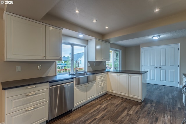 3026 NW Norwood St, Camas, WA 98607 - kitchen featuring dishwasher, a sink, dark wood-style floors, a peninsula, and dark countertops