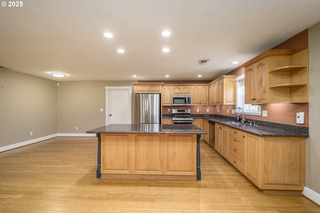 50 W Taylor St, Carlton, OR 97111 - kitchen with appliances with stainless steel finishes, a center island, a sink, a kitchen breakfast bar, and baseboards