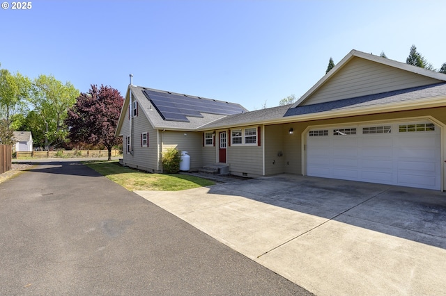 50 W Taylor St, Carlton, OR 97111 - ranch-style home featuring driveway, a shingled roof, an attached garage, and solar panels