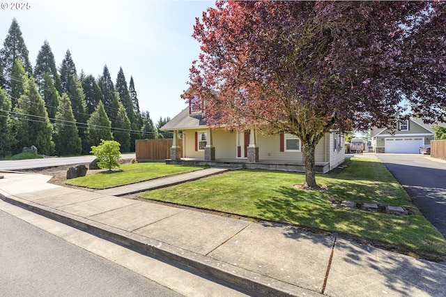 50 W Taylor St, Carlton, OR 97111 - view of property hidden behind natural elements featuring an outdoor structure, asphalt driveway, covered porch, and a detached garage