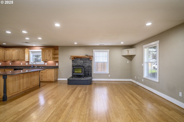 50 W Taylor St, Carlton, OR 97111 - kitchen with open shelves, dark countertops, a sink, light wood-style flooring, and baseboards