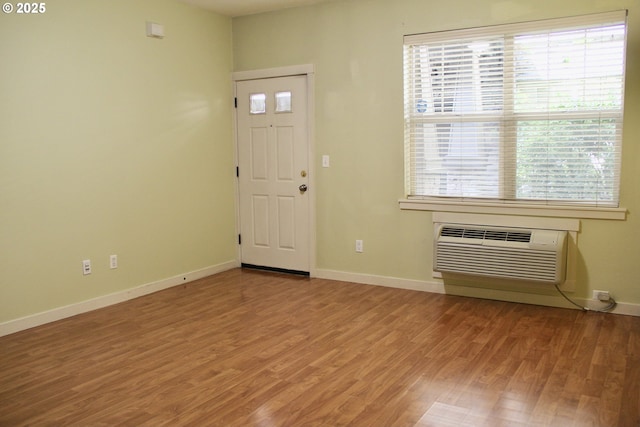 608 NE Roydon Ln, Hillsboro, OR 97006 - entrance foyer featuring plenty of natural light, wood finished floors, and an AC wall unit
