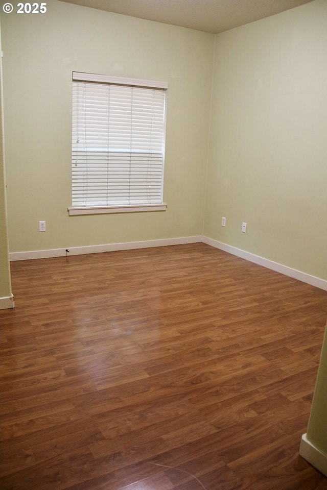 608 NE Roydon Ln, Hillsboro, OR 97006 - spare room featuring wood finished floors and baseboards
