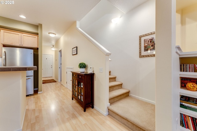 stairs with hardwood / wood-style flooring