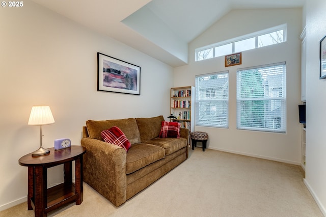 carpeted living room featuring high vaulted ceiling