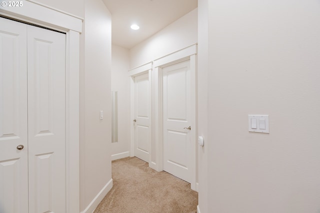 hall featuring recessed lighting, baseboards, and light colored carpet