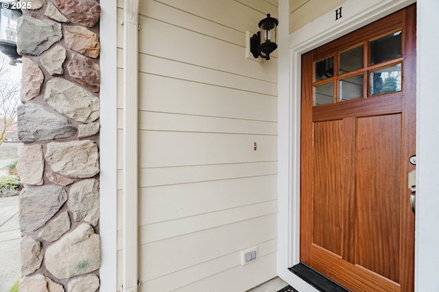 view of exterior entry with stone siding