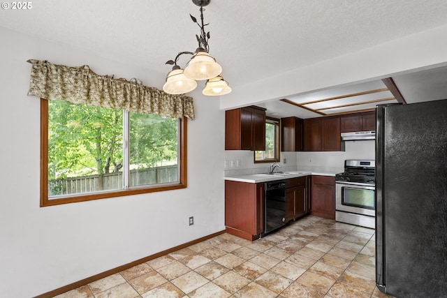 kitchen featuring black appliances, light countertops, under cabinet range hood, a sink, and baseboards