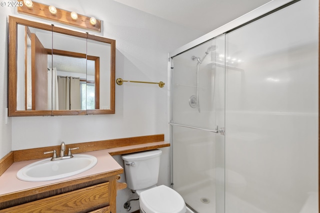 full bathroom with a stall shower, toilet, and vanity