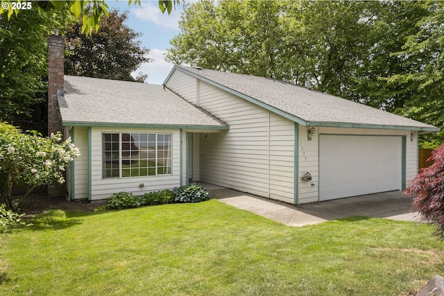 view of front of home featuring a front yard, a chimney, an attached garage, a shingled roof, and driveway