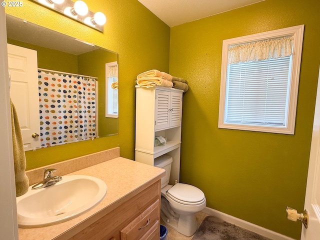 3000 Elm St, Baker City, OR 97814 - bathroom featuring vanity, toilet, curtained shower, and tile patterned flooring