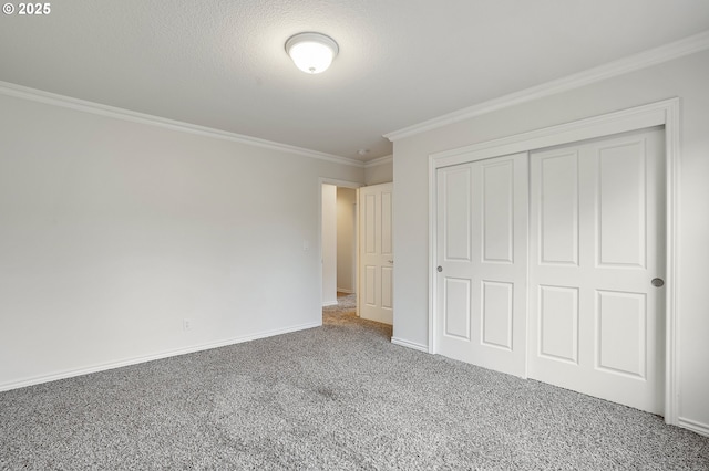 unfurnished bedroom with a closet, crown molding, and carpet flooring