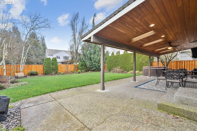 view of patio / terrace featuring ceiling fan and a hot tub