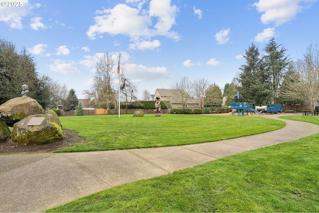 view of community featuring a playground and a lawn