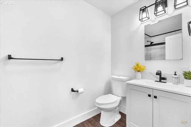 bathroom featuring toilet, walk in shower, wood-type flooring, and vanity