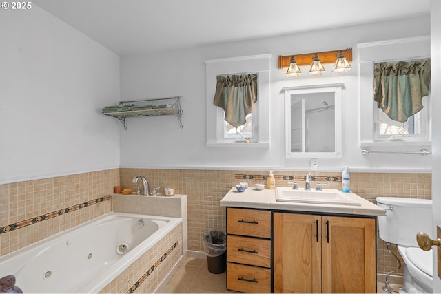 bathroom featuring tile patterned flooring, a jetted tub, tile walls, and toilet