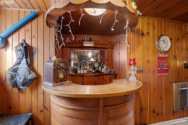 bar featuring wood ceiling, wood walls, a dry bar, and heating unit