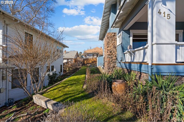 view of side of property featuring a yard