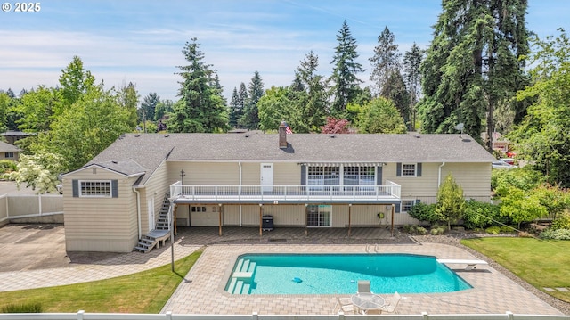 11675 SW Lynn St, Portland, OR 97223 - rear view of house with a patio area, a wooden deck, stairway, an outdoor pool, and a chimney