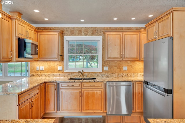11675 SW Lynn St, Portland, OR 97223 - kitchen featuring appliances with stainless steel finishes, a sink, ornamental molding, light stone counters, and plenty of natural light