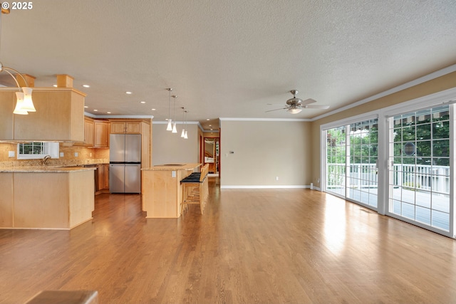 11675 SW Lynn St, Portland, OR 97223 - kitchen with freestanding refrigerator, ornamental molding, light brown cabinetry, ceiling fan, and tasteful backsplash