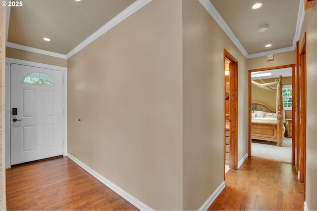 11675 SW Lynn St, Portland, OR 97223 - entrance foyer featuring wood finished floors, baseboards, recessed lighting, ornamental molding, and a textured ceiling