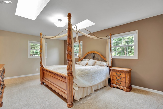 11675 SW Lynn St, Portland, OR 97223 - bedroom with a skylight, multiple windows, light colored carpet, and baseboards