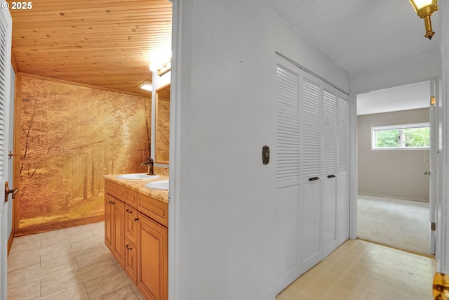 11675 SW Lynn St, Portland, OR 97223 - bathroom featuring double vanity, tile patterned floors, a textured ceiling, and a closet