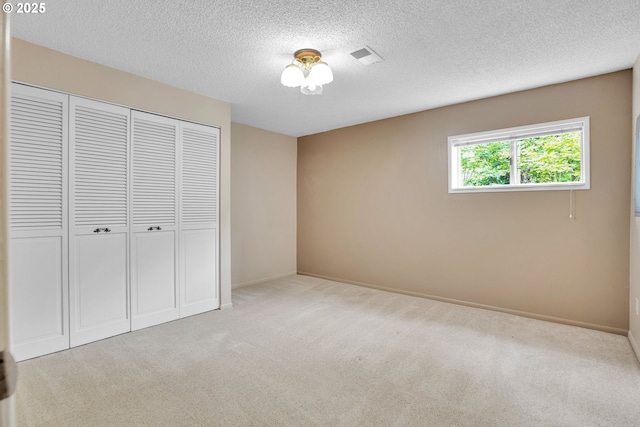 11675 SW Lynn St, Portland, OR 97223 - unfurnished bedroom with carpet flooring, a closet, a textured ceiling, and baseboards
