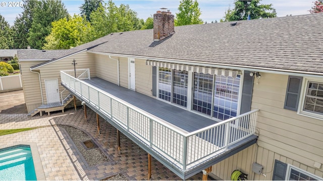 11675 SW Lynn St, Portland, OR 97223 - back of property with a chimney, an outdoor pool, and a shingled roof