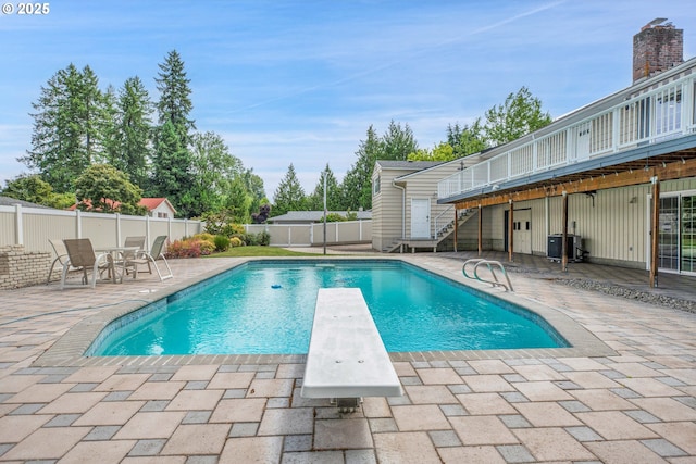 11675 SW Lynn St, Portland, OR 97223 - view of pool featuring a patio, stairs, a diving board, and a fenced backyard