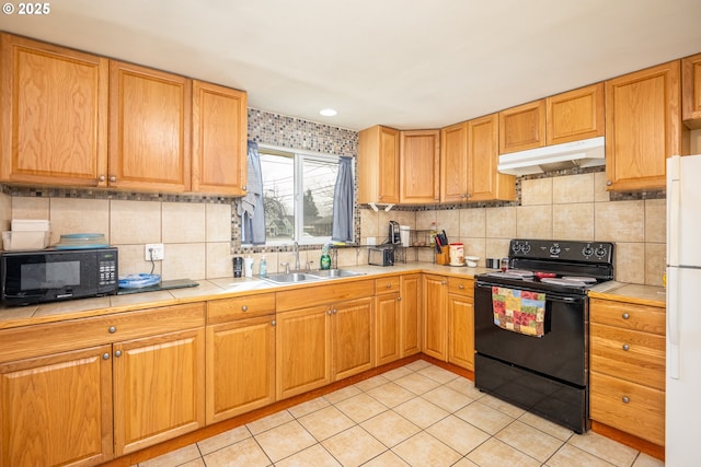 kitchen with black appliances, backsplash, a sink, and under cabinet range hood