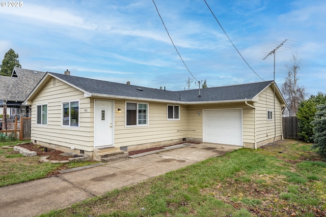 back of house featuring entry steps, an attached garage, fence, concrete driveway, and a yard