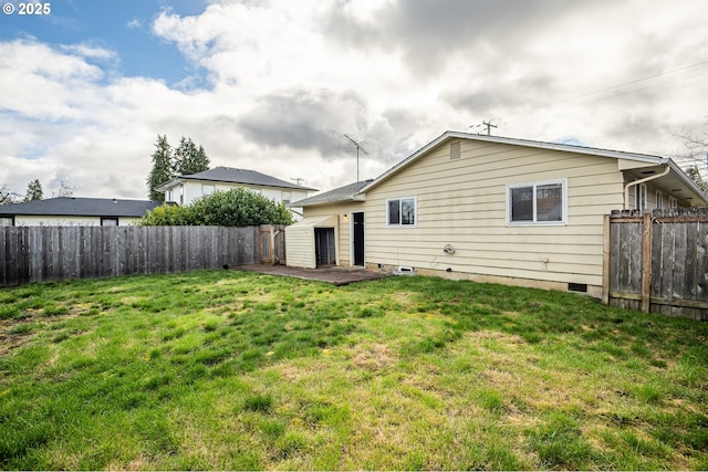 rear view of property with a fenced backyard, a patio, and a yard