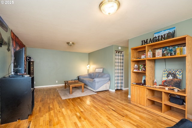 living room featuring light wood-type flooring and baseboards