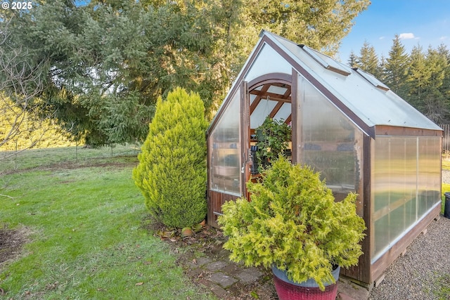 view of outbuilding featuring a yard