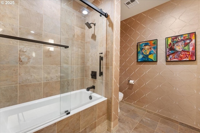 525 SE Marion St # 2, Portland, OR 97202 - bathroom with tiled shower / bath combo, toilet, and tile walls